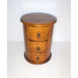 A bedside set of three drawers, diameter 45cm, height 61cm.