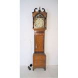 An oak longcase clock, with painted dial depicting Daniel in the lion's den, the hood with eagle