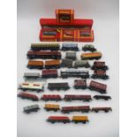 A collection of various OO gauge model railway rolling stock, carriages, tankers, wagons, good vans,