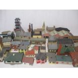A large collection of model railway buildings including shops, petrol garage, cottages, churches,