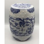 A Chinese pottery stool with blue and white dragon detail - height 47cm