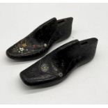 A pair of decorative cast iron shoe lasts