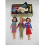 A collection of three vintage Sindy dolls (all Numbered 033055X), along with a selection of outfits
