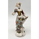 A Meissen style figure of a woman carrying flowers with a lamb at her feet, cursive signature to