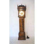 An inlaid oak longcase clock, with brass and silvered dial (repainted).