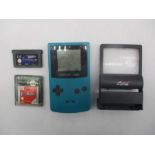 A Nintendo Game Boy Colour handheld games console (Model No CGB-001) with two games and screen