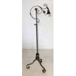 An Art Nouveau wrought metal floor lamp on scrolled feet with foliate detail - height 130cm