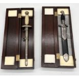 Two cased WW2 replica German daggers