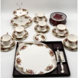 A collection of Royal Albert Country Roses including six trios, large cheese plate, cake stand etc.