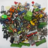 A large quantity of plastic toys including tractors, farm animals, fences, hedges etc