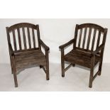 A pair of wooden garden chairs