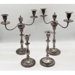 Two pairs of silver plated candlesticks and candelabra, one pair with family emblem to base A/F