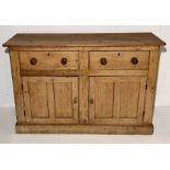 A rustic pine sideboard with two drawers and cupboard under