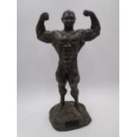 A bronzed resin figure of a male bodybuilder - height 49cm