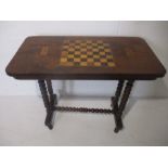 A Victorian games table on bobbin turned legs