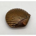 A brass vesta case in the form of a clam shell
