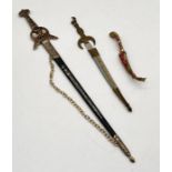 Three Eastern daggers - two with decorated scabbards and another larger replica