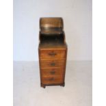 An Edwardian Davenport style bedside cabinet, with four drawers.