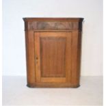 An oak corner cupboard.