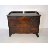 A Georgian style mahogany low bow fronted chest of three drawers, length 107cm, height 80cm, depth