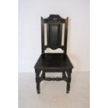 An antique oak hall chair.