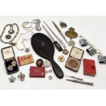 A collection of miscellaneous items including ebony mirror, military badge, coral necklace,