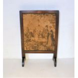 An oak fire screen with tapestry design.