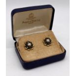 A pair of 9ct gold earrings set with emeralds and seed pearl, total weight 3g