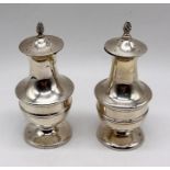 A pair of hallmarked silver pepperettes