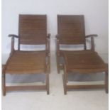 A pair of teak steamer chairs