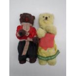 A pair of vintage clockwork bears (male brown and female white) both dressed in Russian style