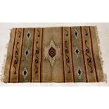 An Eastern cream ground rug with geometric design 186cm x 117cm