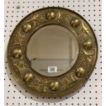 An Arts & Crafts Keswick School of Industrial Art circular brass mirror with bevelled plate, stamped