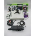 An Xbox 360 games console with accessories including three controllers, power pack/cable,