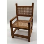 A vintage child's cane seat chair
