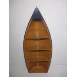 A novelty bookcase in the form of a rowing boat, height 135cm