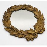 A turn of the century circular wall mirror with bronze frame in the form of a laurel wreath 42cm x