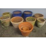 A collection of garden pots including terracotta and two blue glazed Heritage Garden pots.