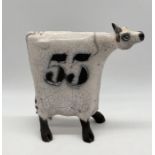 Lawson Rudge (born 1936) a stylised Raku pottery cow numbered 55 with spotted pattern - Height 25cm