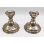 A pair of hallmarked silver dwarf candlesticks