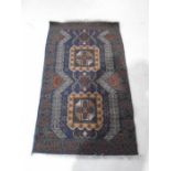 A blue ground hand woven Eastern rug