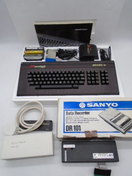 A boxed Memotech MTX512 S2 computer with power supply, memory and other accessories, along with a