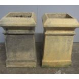 A pair of weathered buff terracotta chimneys.