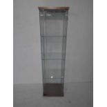 A freestanding glass display cabinet