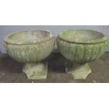 Two weathered garden planters, both have damage to base. Height 34cm