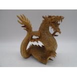 An Oriental carved figure of a dragon, height 21cm