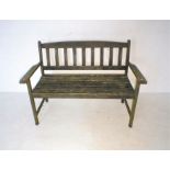 A weathered wooden garden bench, length118cm.