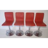 Four matching red bar stools with chrome base.