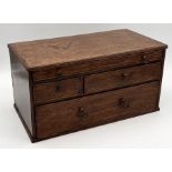 A turn of the century oak table top chest of four drawers