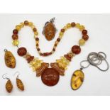 A collection of amber and amber fleck jewellery
